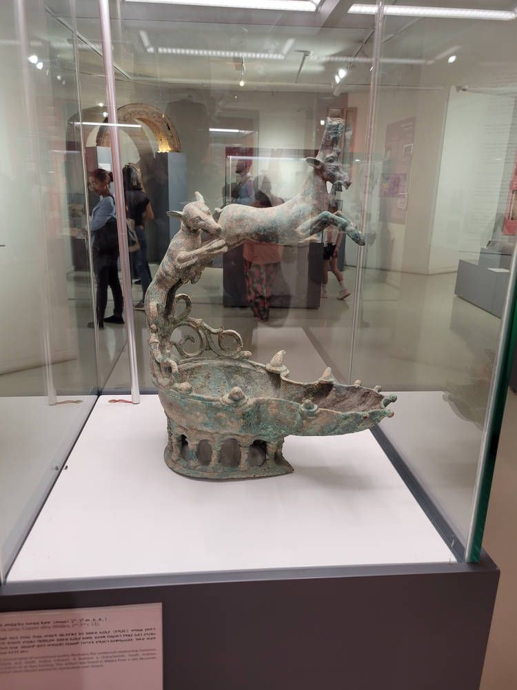 A bronze piece in a glass case