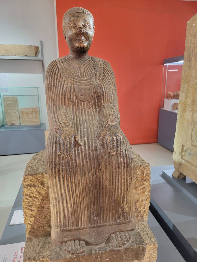 A seated stone figure