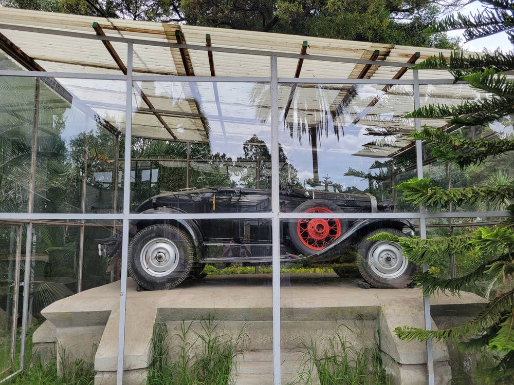 An old car under a glass shelter