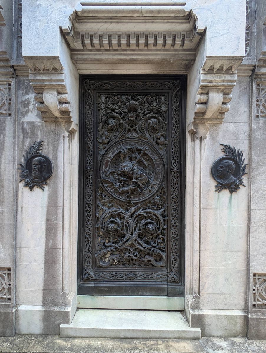 A carved bronze door on a tomb