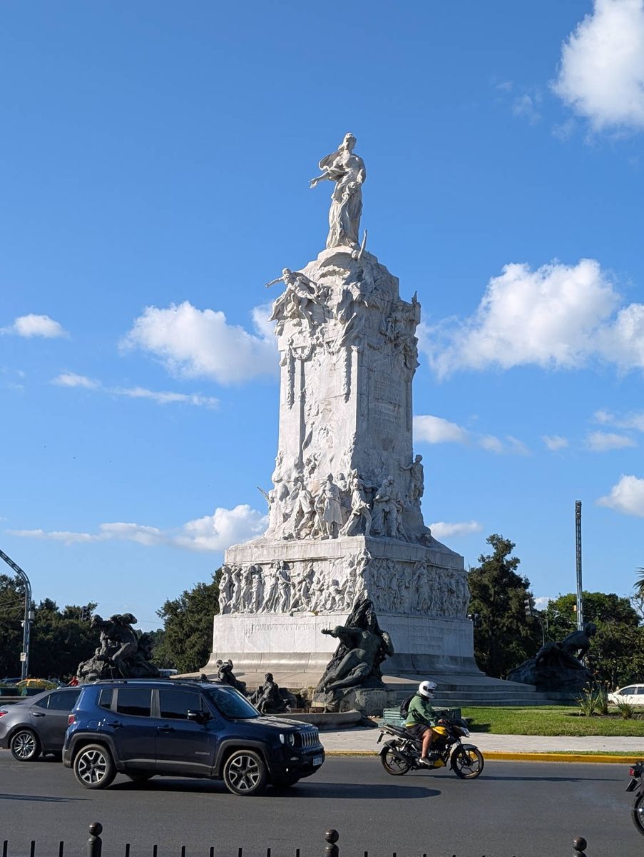 A white monument at a traffic circle