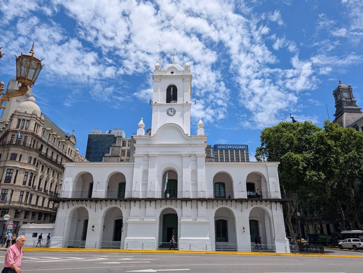 The white colonial building with the clock tower