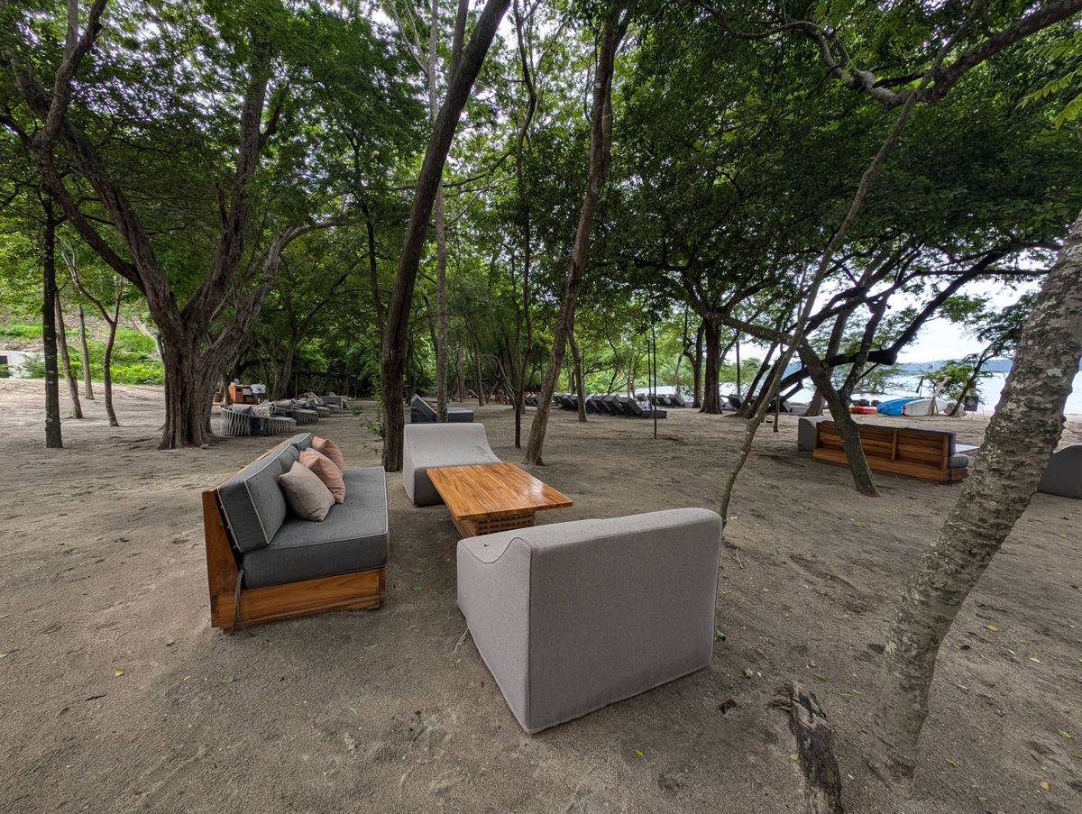 Sofas on the sand in the shade