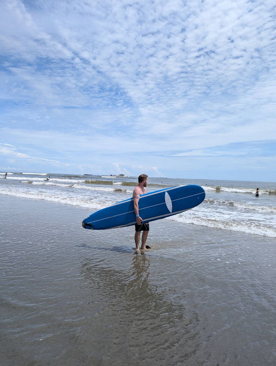 Brendan with a rented surfboard
