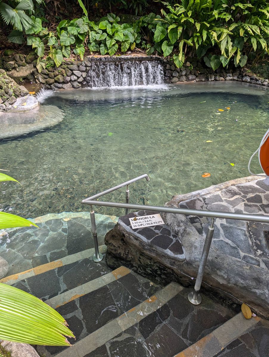 A thermal pool with a small waterfall