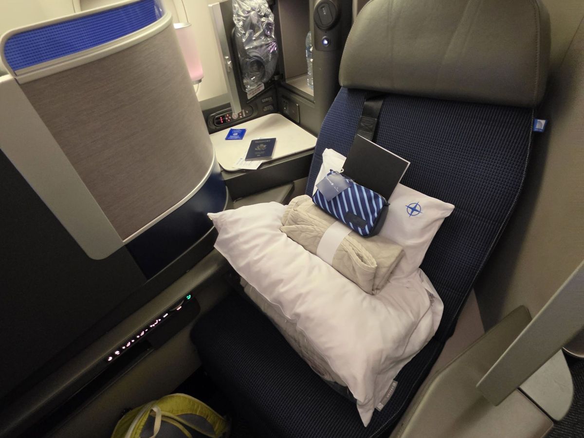 A United Polaris business class seat by the window