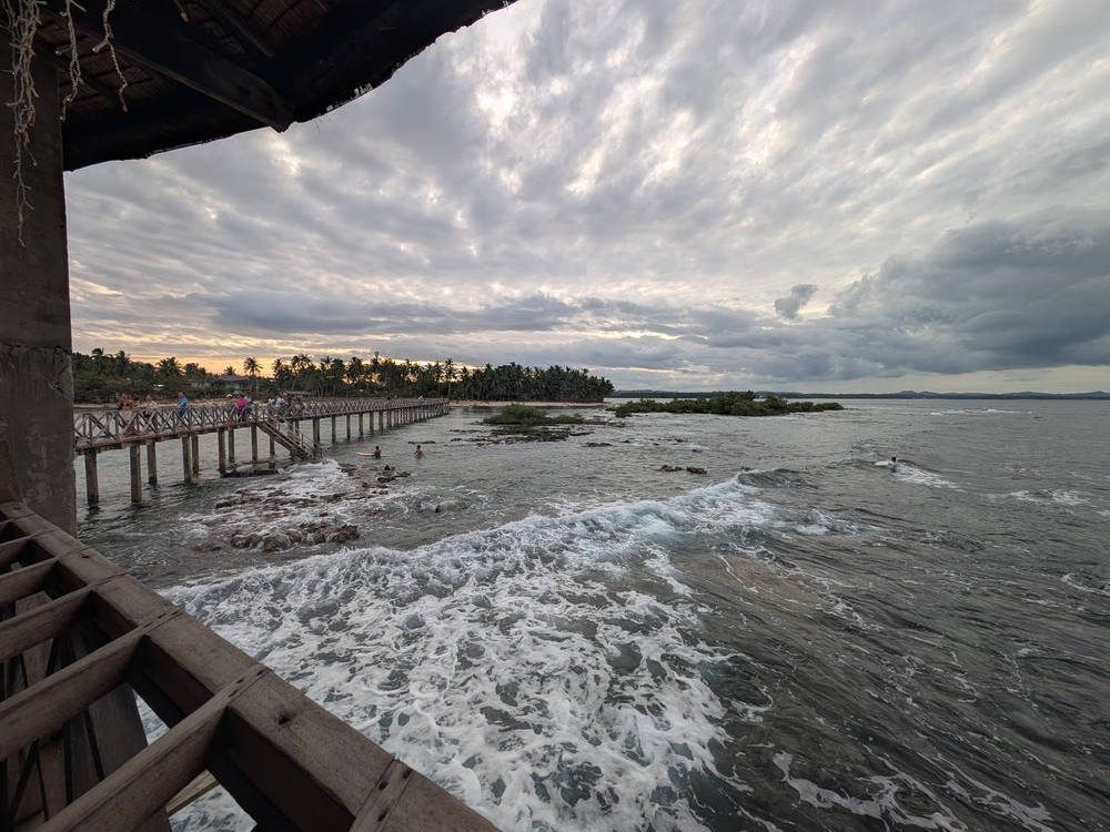 Waves on the rocks under a big sky, Siargao