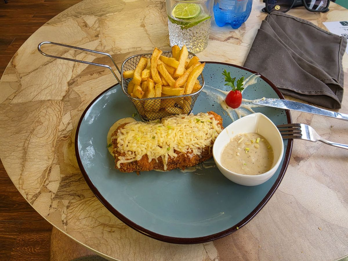 Breaded chicken under melted cheese. Dry, with no flavor. I suspect it came out of the freezer for the foreigner.