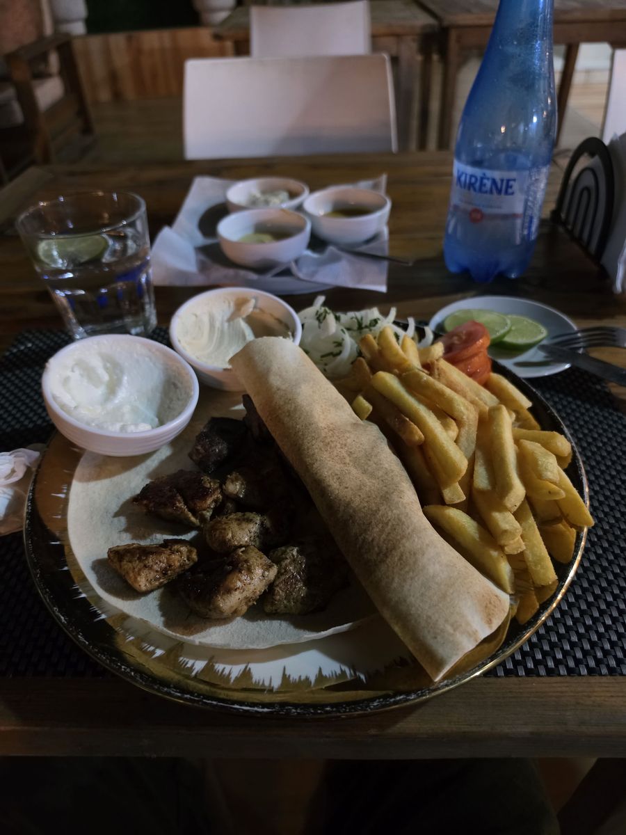 Mixed kebab with fries, garlic sauce and Kirène water