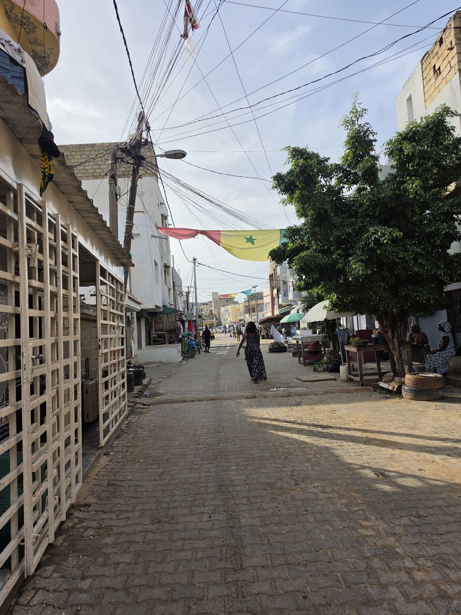 A Senegalese flag strung over the street