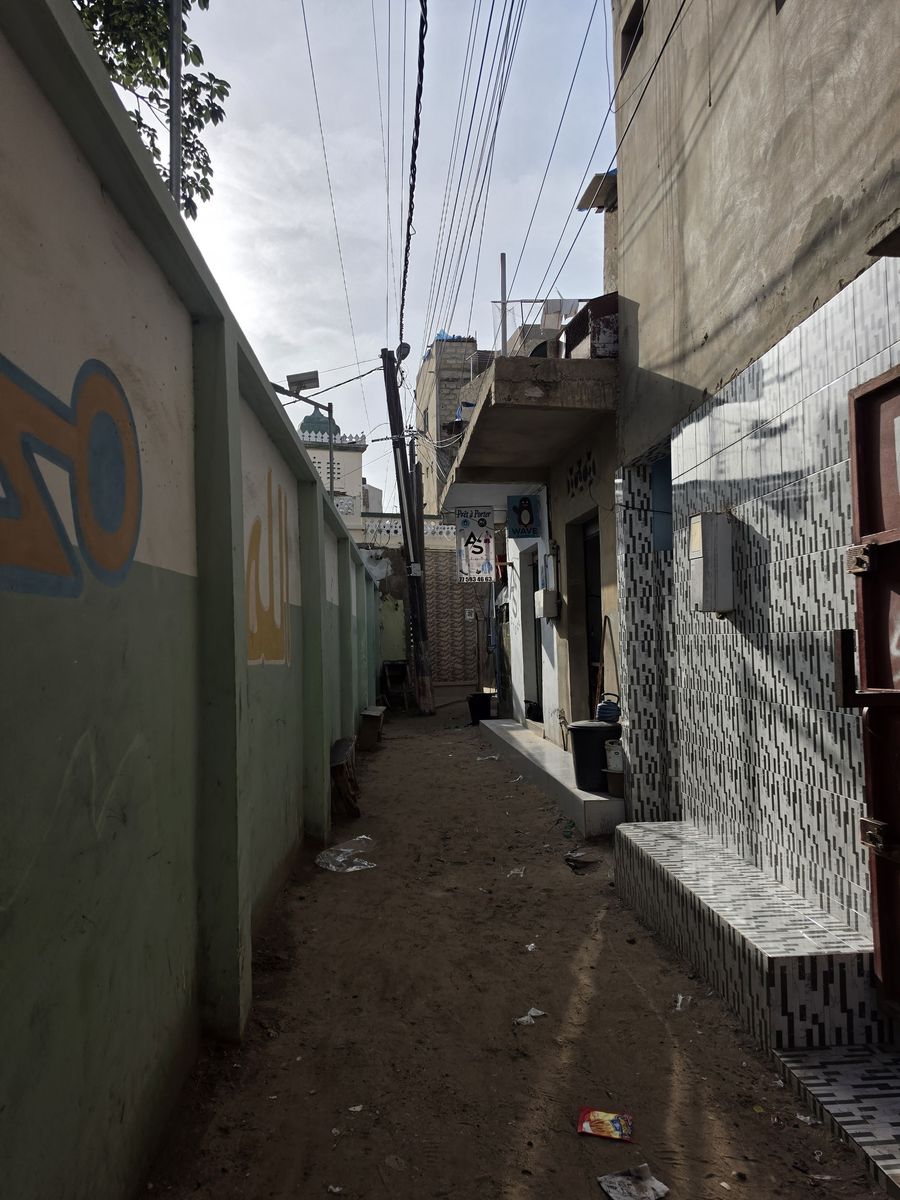 A narrow lane with a minaret at the end
