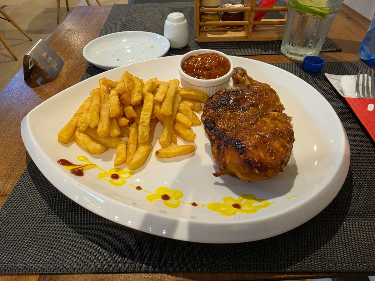 Grilled chicken and fries at the hotel restaurant