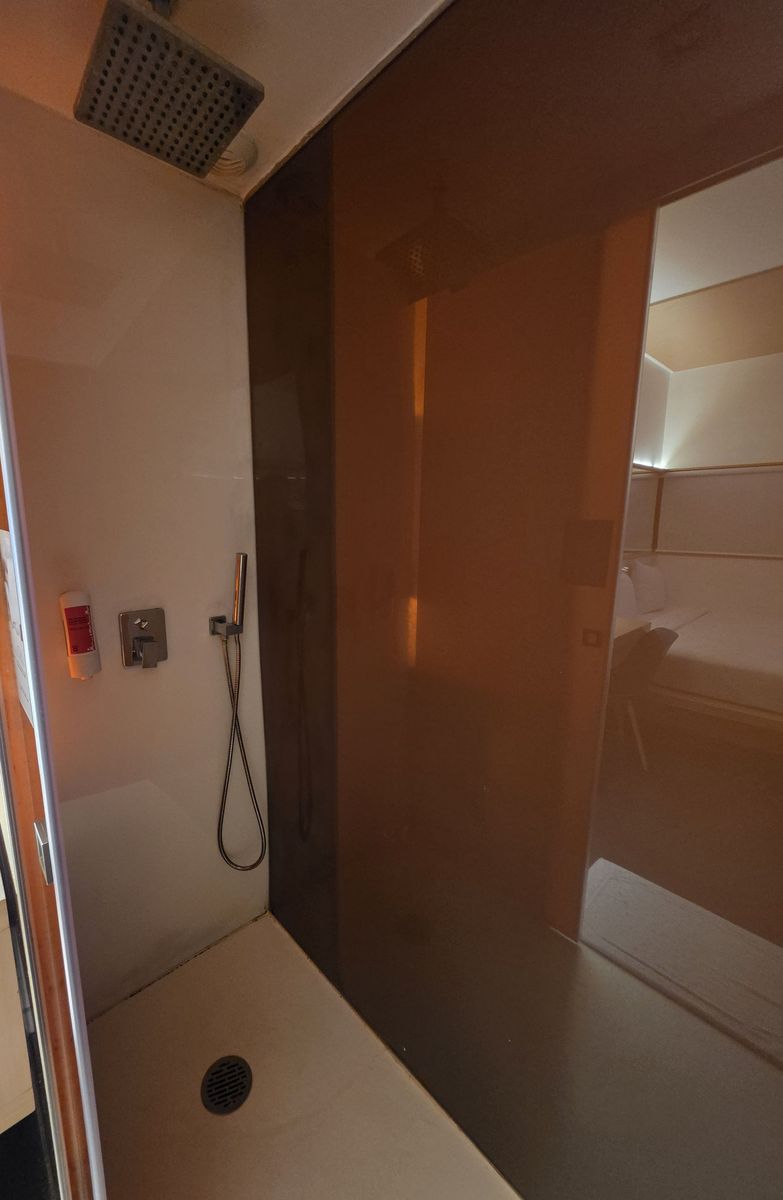 The shower, which opens straight onto the sink and bed