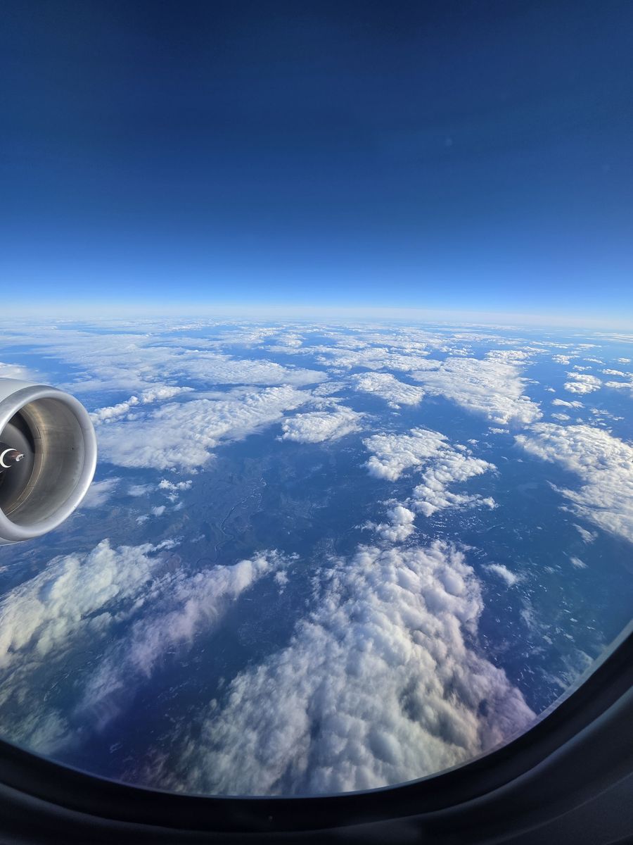 Clouds over land, late in the flight