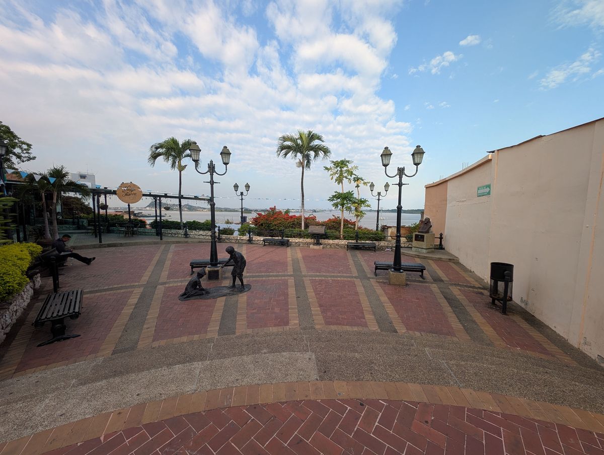 A small plaza over the river, with a bronze of two children playing