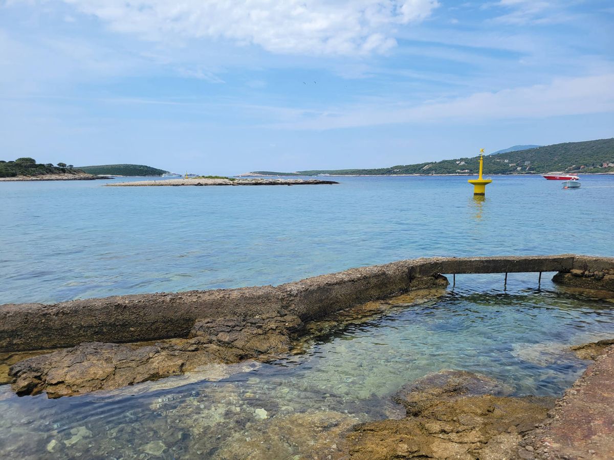 A stone jetty and clear water