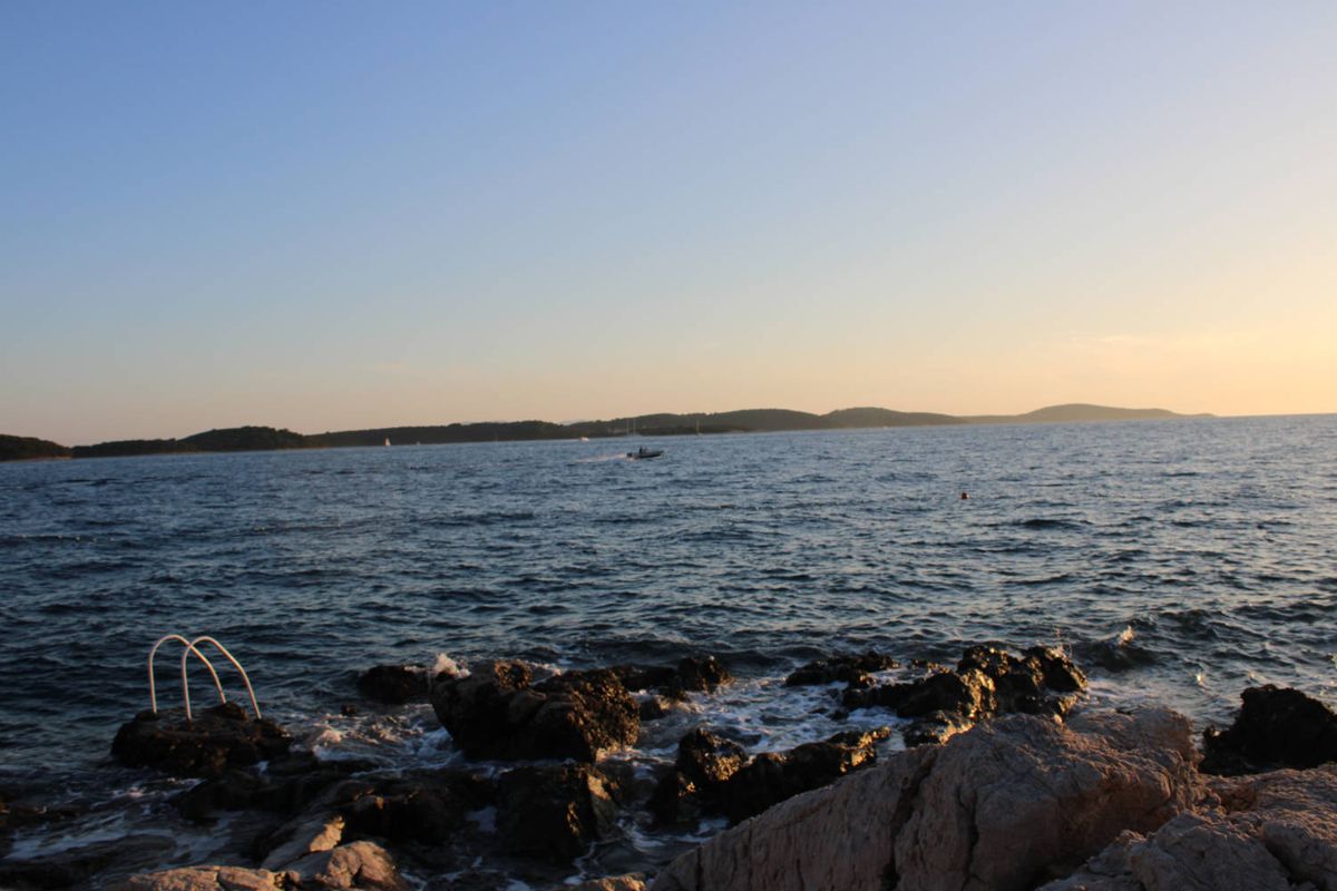A ladder into the sea at dusk