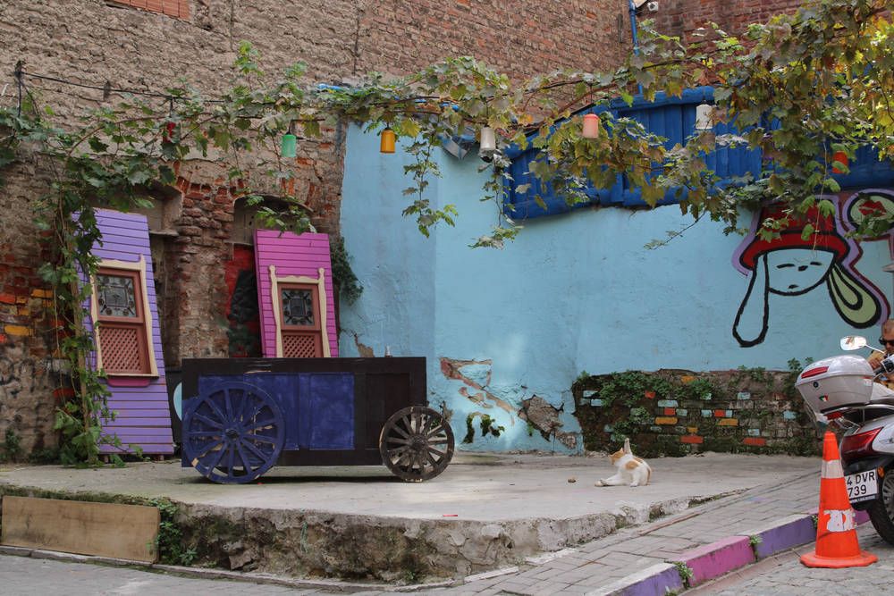 A painted wall with a cart and old shutters