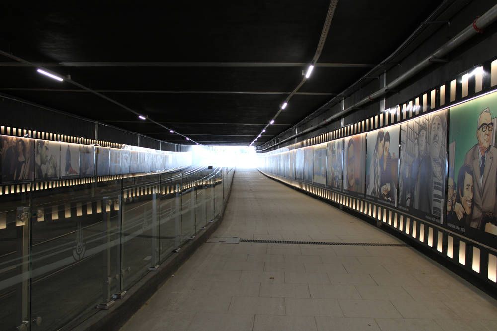 A lit underpass with murals