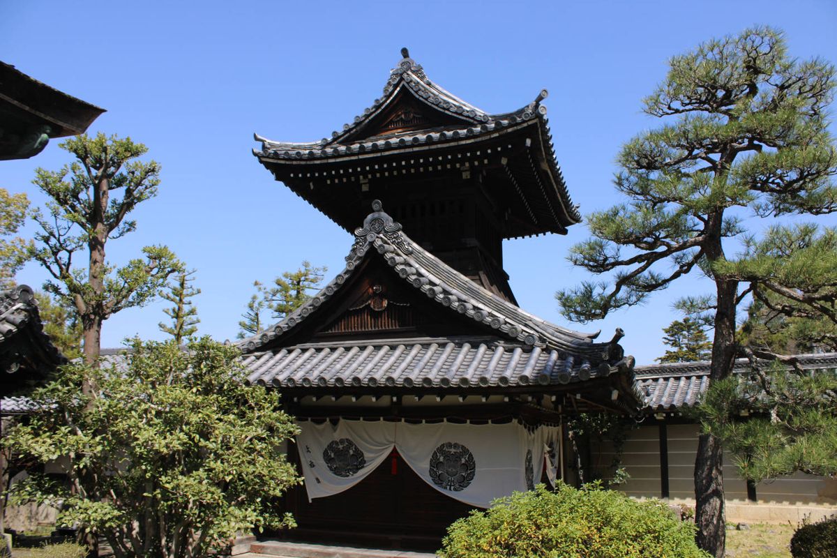 A two-story temple tower among pines