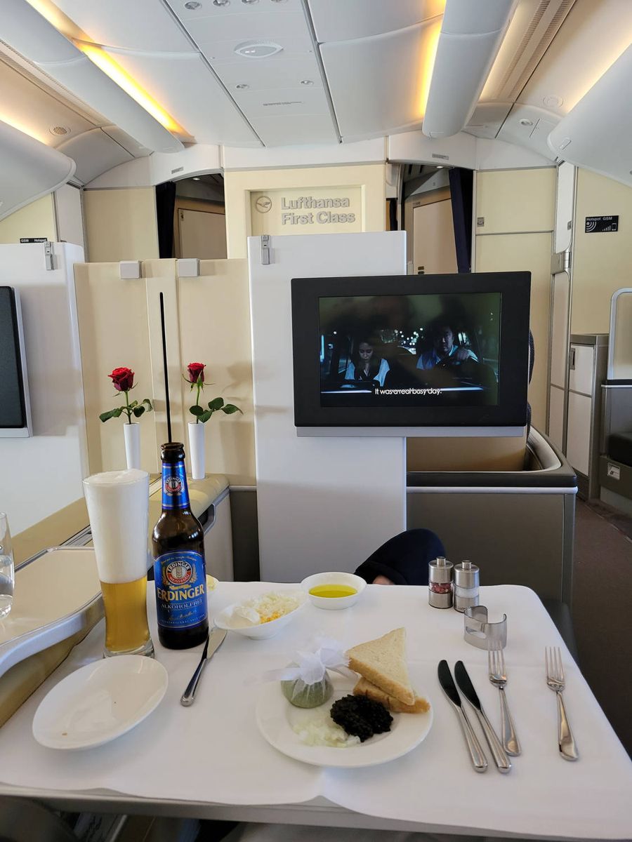 Caviar and an alcohol-free Erdinger, the Lufthansa First Class sign behind
