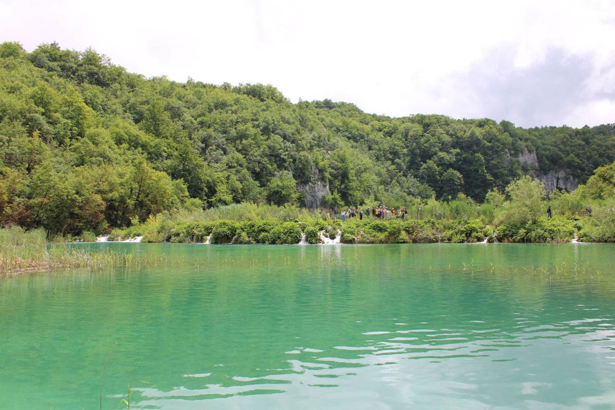 Small falls along the far edge of a lake