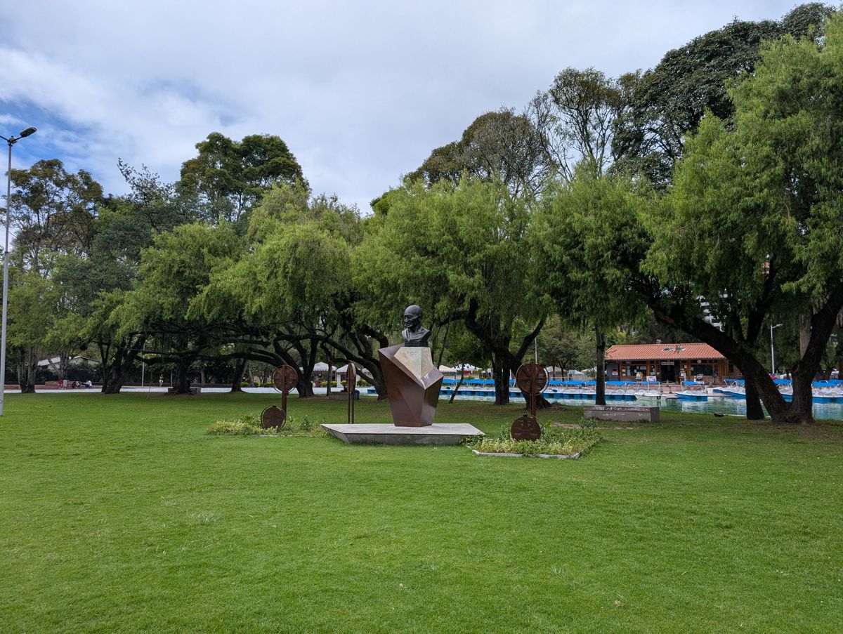 A bronze bust, with the pedal boats behind