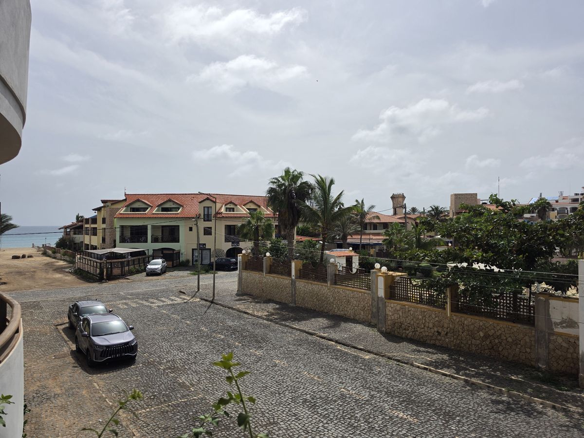 The balcony view, with the beach at the end of the street
