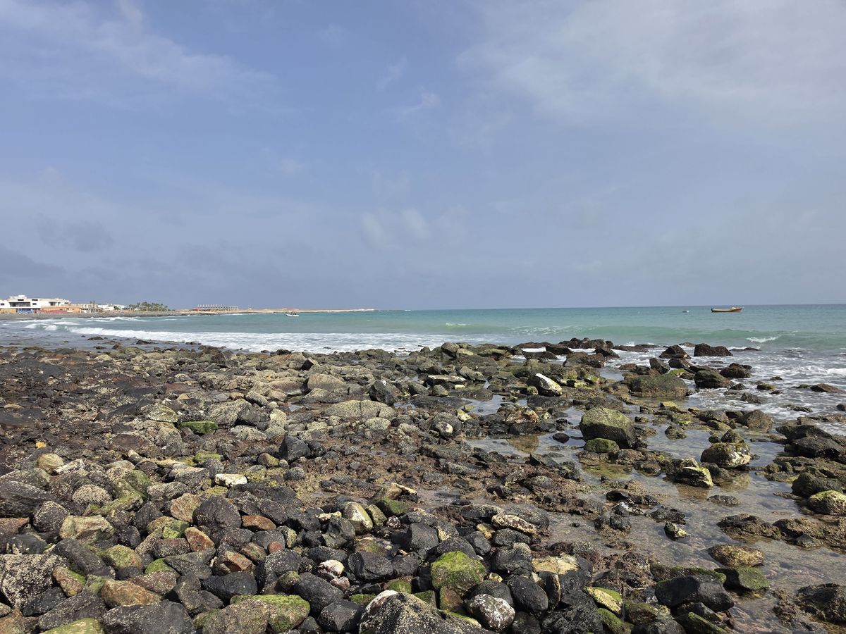 Rocks and turquoise water past town