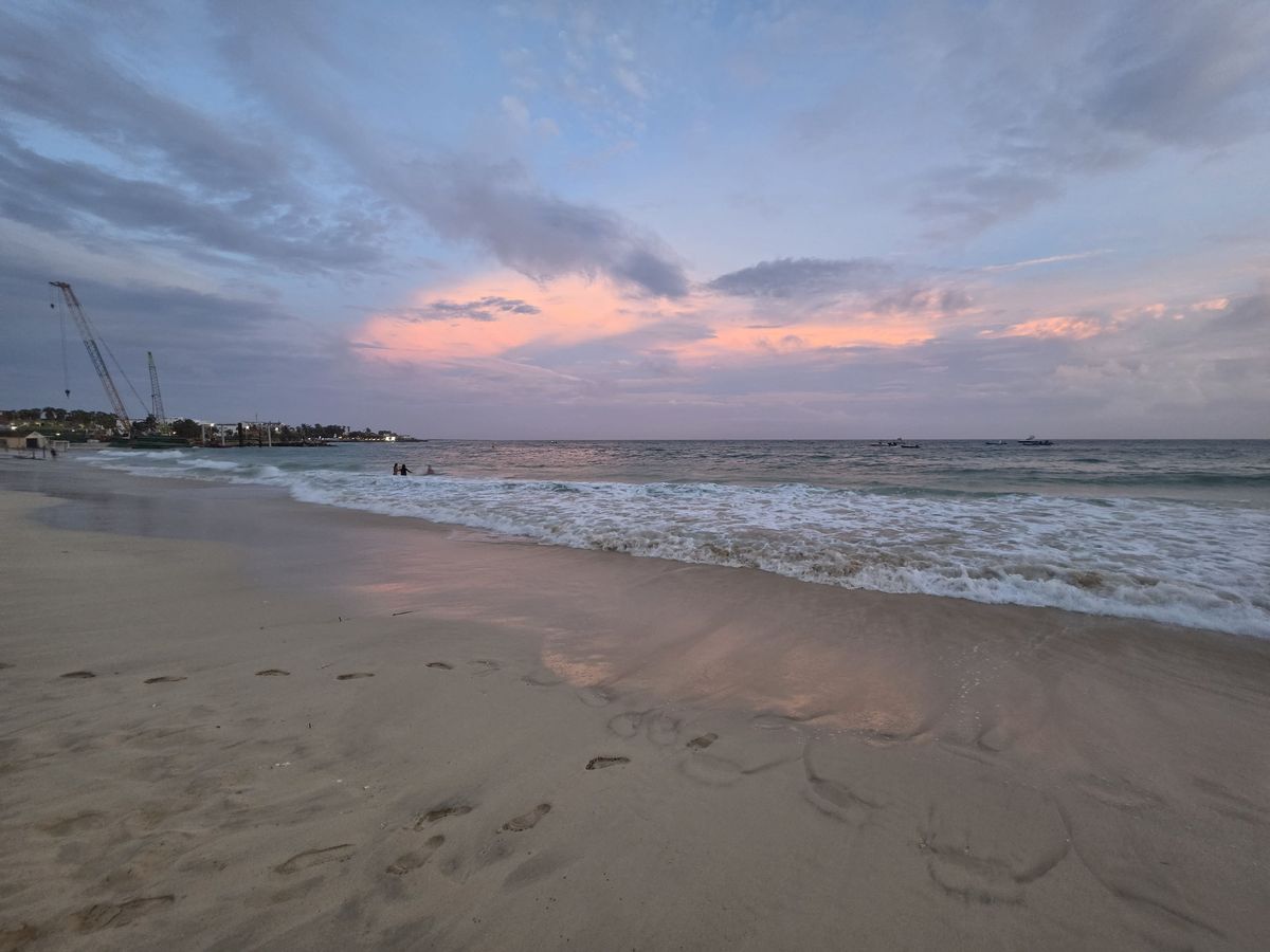 Pink clouds over the water at sunset
