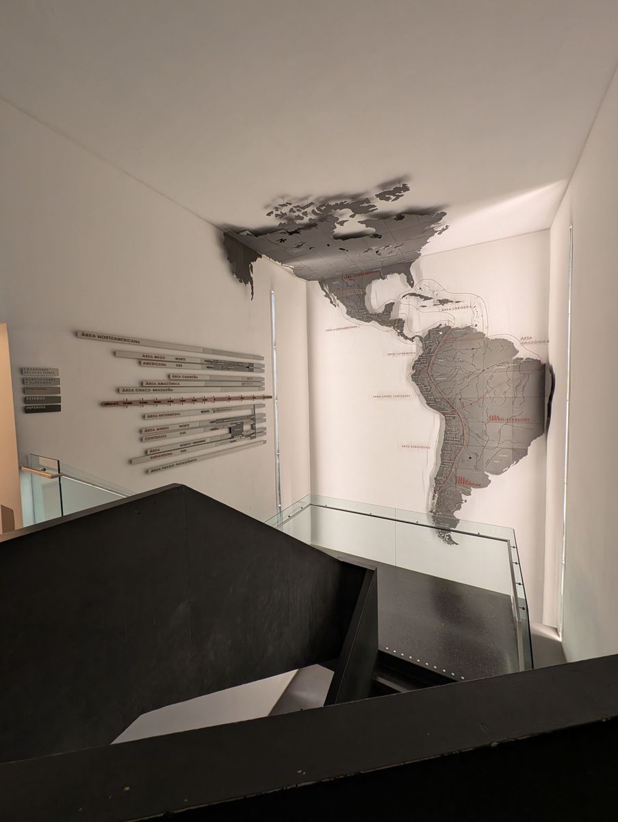 The map of the Americas over the stairwell, with the timeline of cultures beside it
