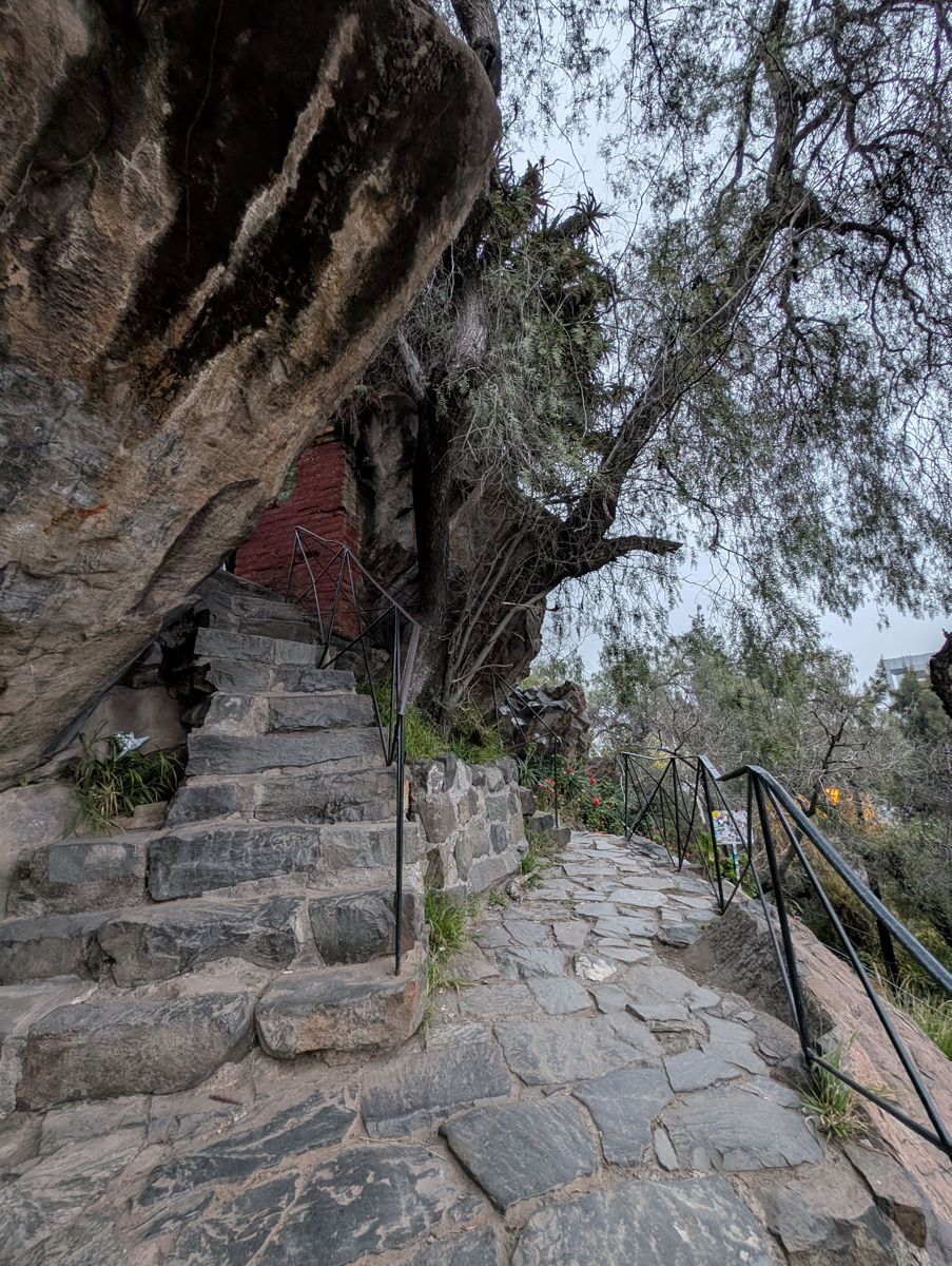 Steps tucked under a boulder
