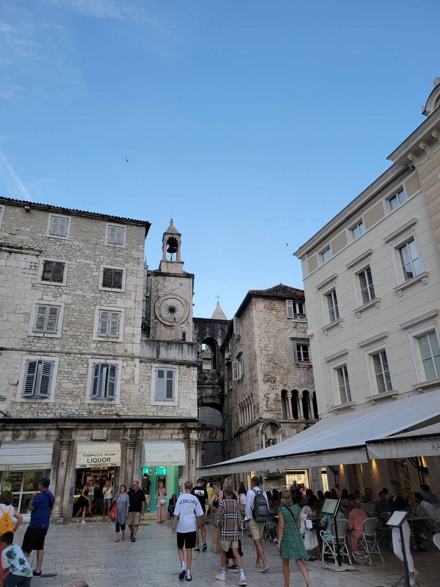 A busy square with a clock tower