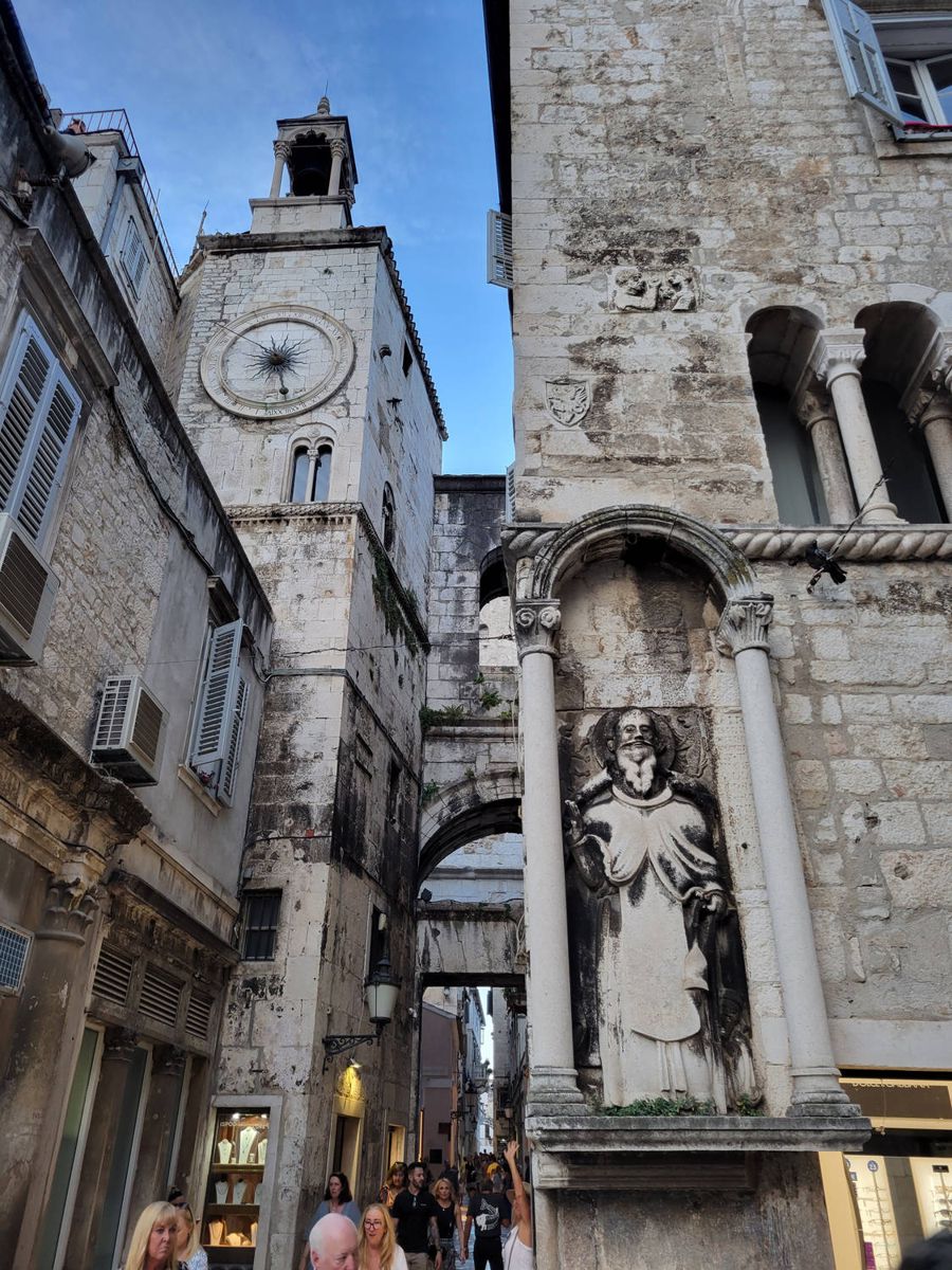 A clock tower and a carved figure