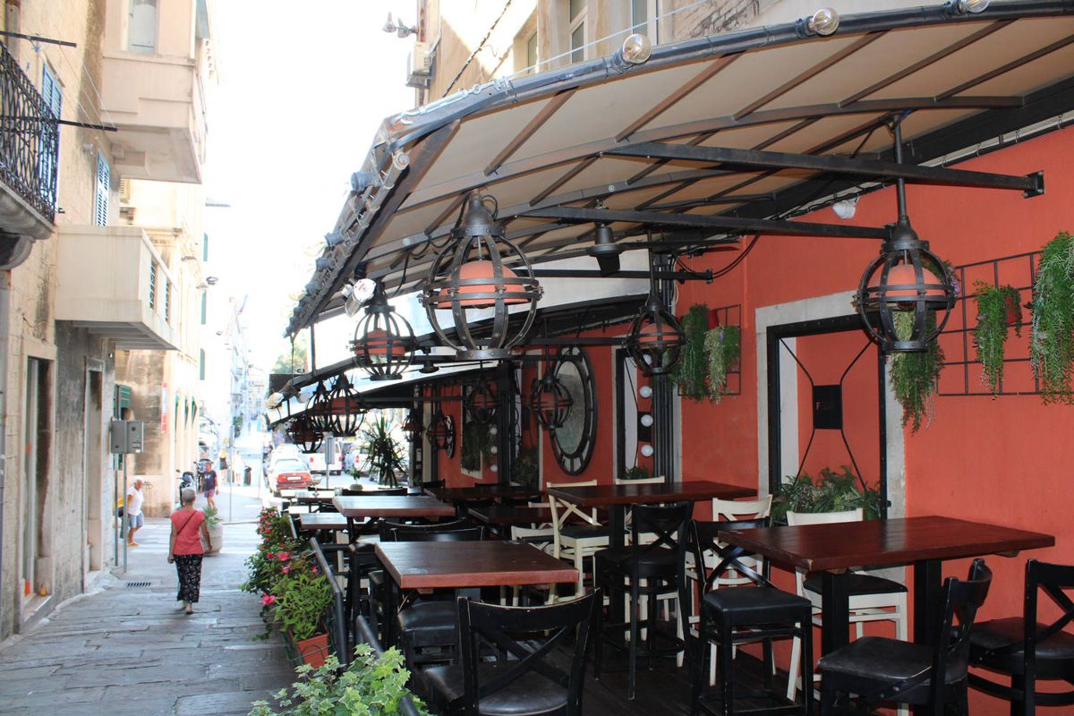 Café tables under an awning