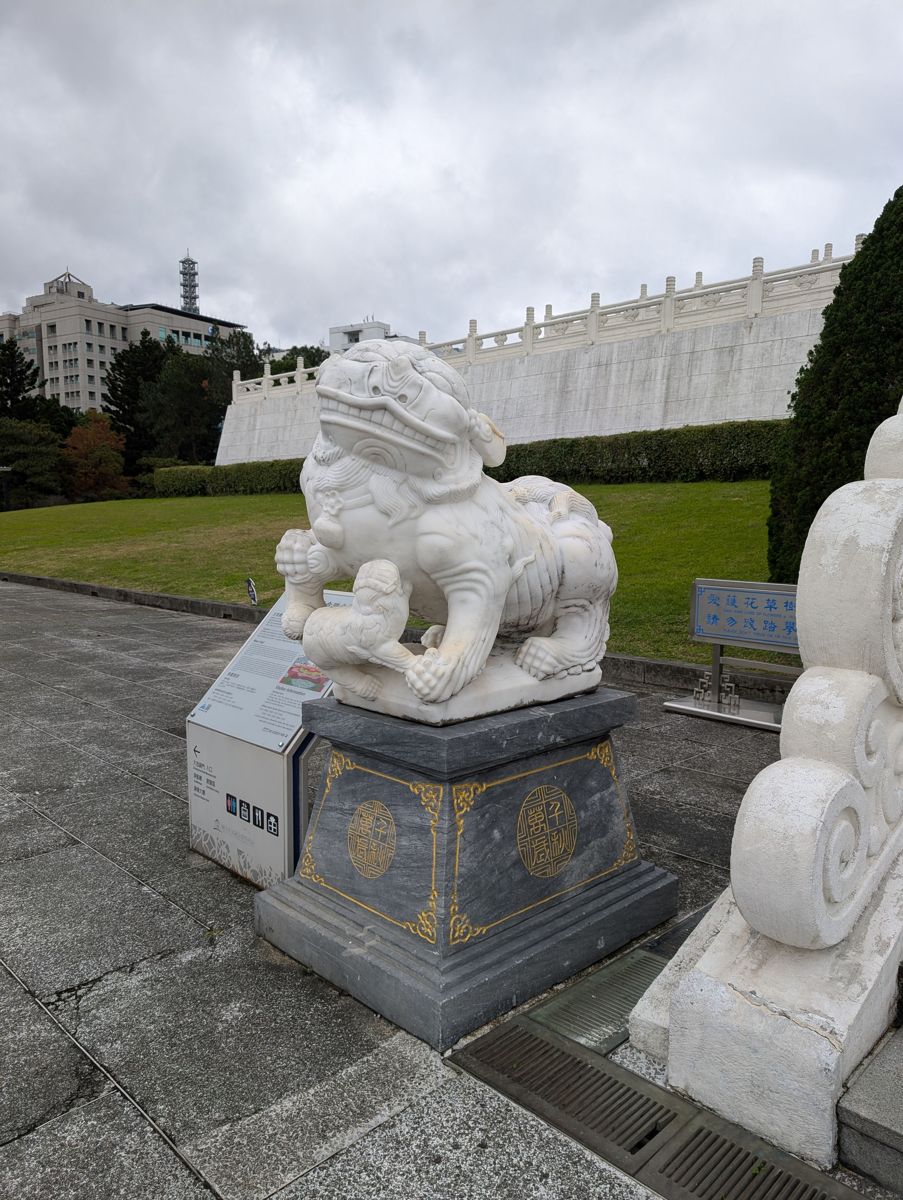 A marble guardian lion at the foot of the stairs
