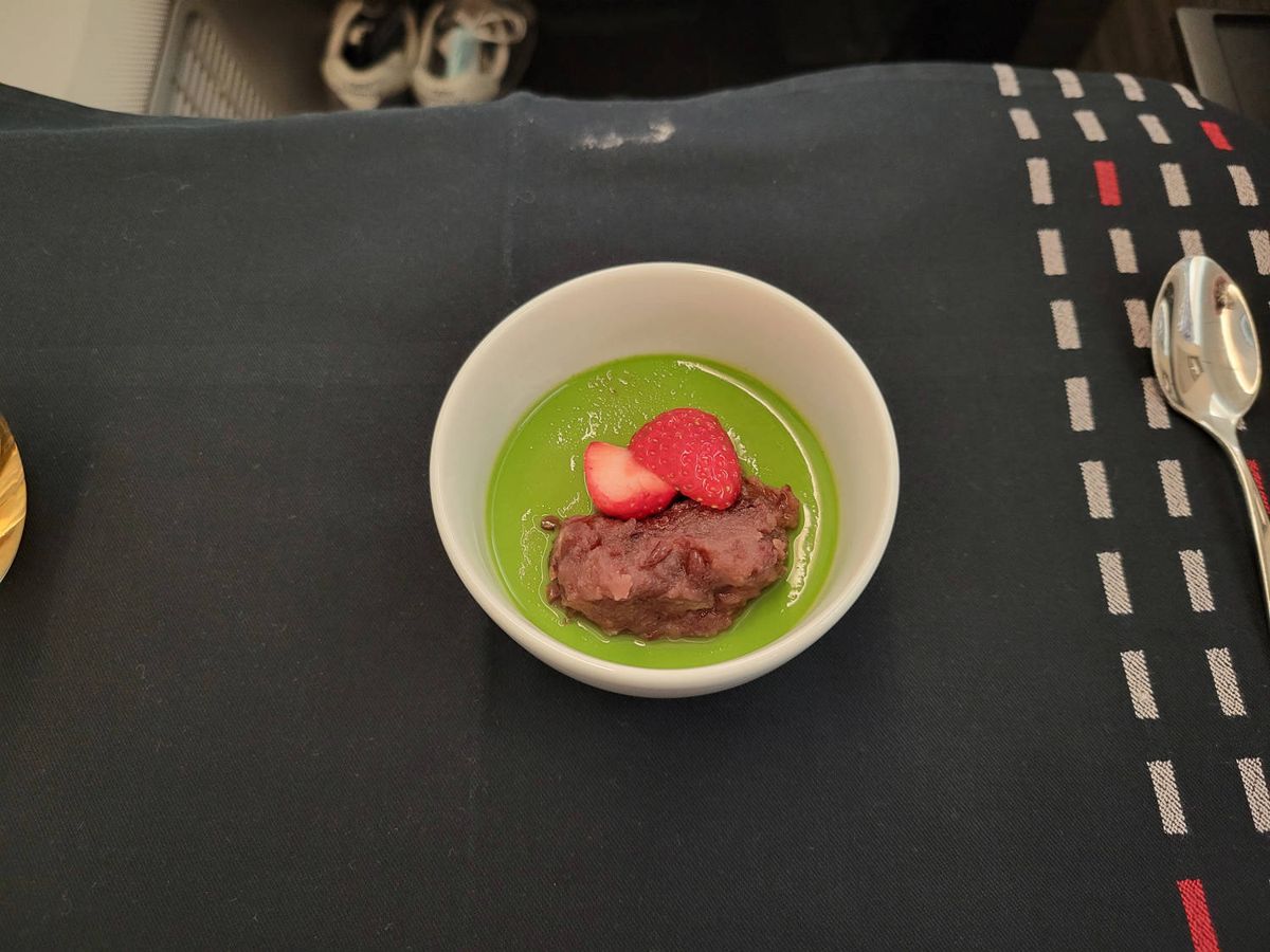 Matcha pudding with red bean and a strawberry