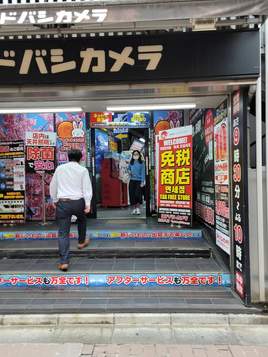 A camera shop entrance in neon