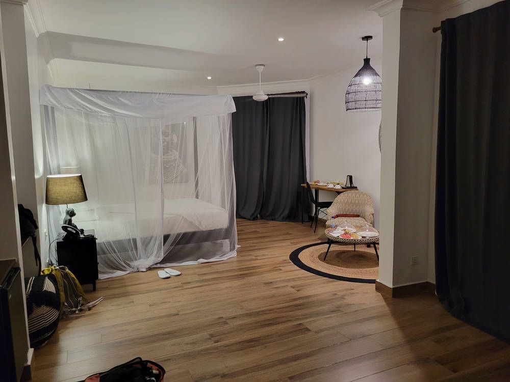 The room at night, with a mosquito net over the bed